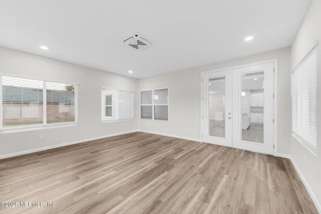 a bedroom with a large bed and a potted plant