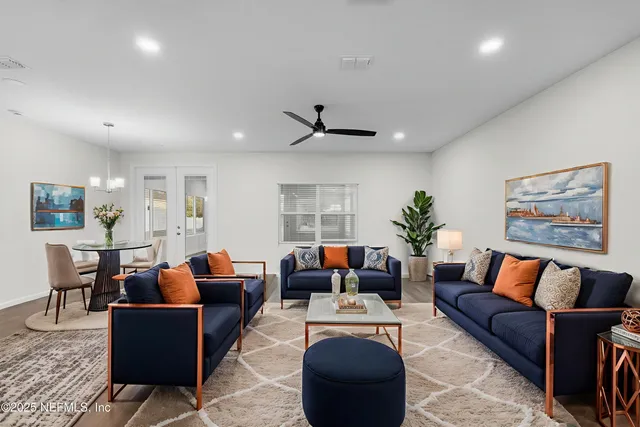 a view of a room with wooden floor and kitchen view