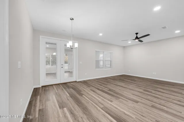 a view of kitchen with kitchen island stainless steel appliances cabinets and wooden floor