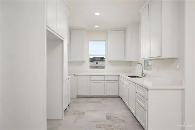 a kitchen with a sink cabinets and window