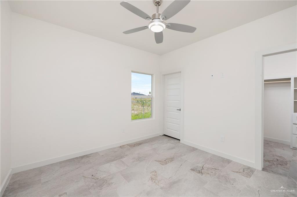 321 Merida Drive Donna, TX 78537 - Photo 5 of 11 an empty room with a window and a fan