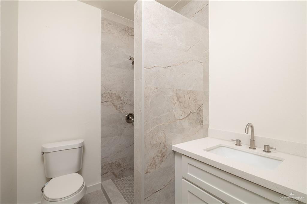 321 Merida Drive Donna, TX 78537 - Photo 6 of 11 a bathroom with a granite countertop sink toilet and shower