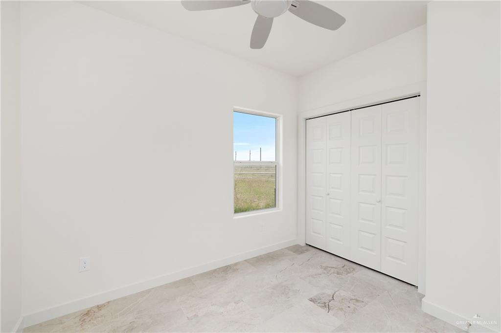 321 Merida Drive Donna, TX 78537 - Photo 7 of 11 an empty room with windows and fan