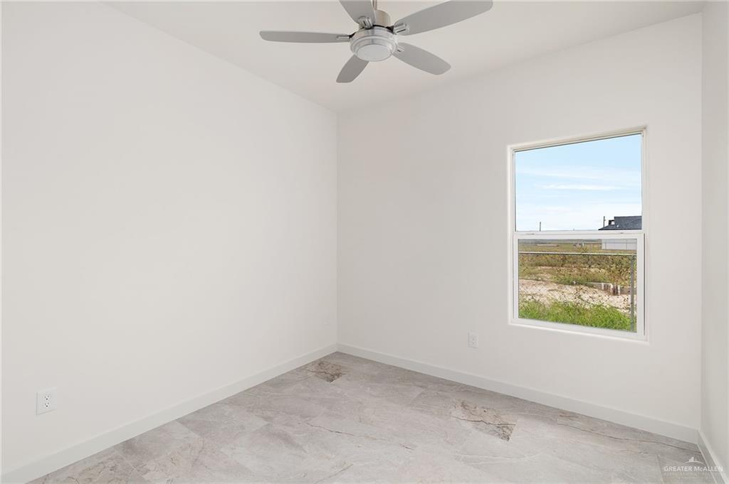 321 Merida Drive Donna, TX 78537 - Photo 8 of 11 an empty room with a window and a fan