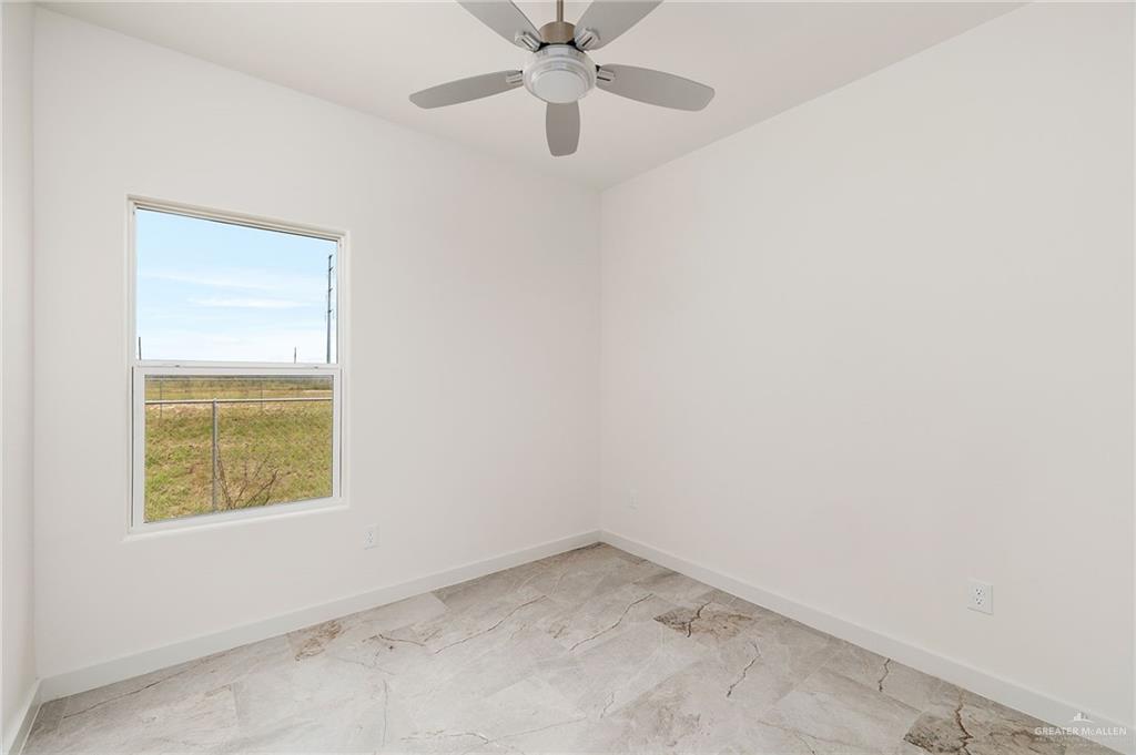 321 Merida Drive Donna, TX 78537 - Photo 9 of 11 an empty room with a window and a fan