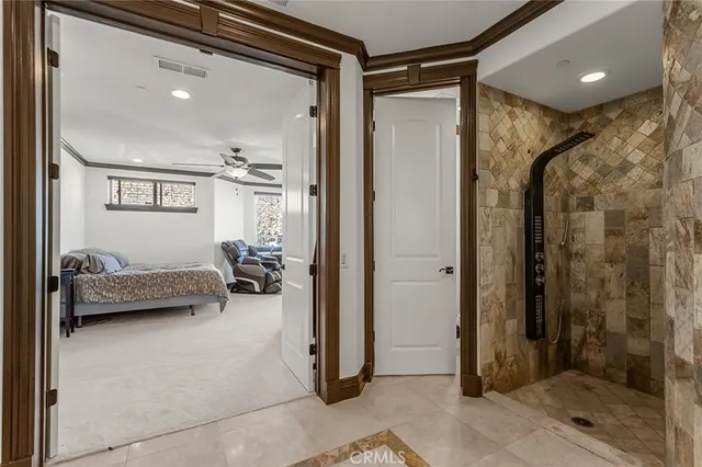 a bedroom with a large bed and a large window