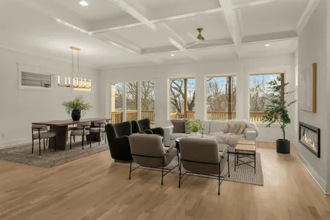 a living room with furniture and a view of kitchen