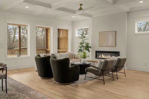 a kitchen with stainless steel appliances granite countertop a sink a stove a refrigerator and island with wooden floor