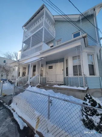 a front view of a house with sitting area