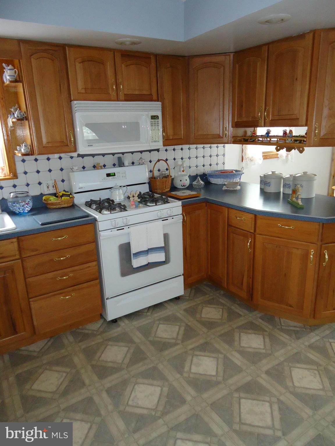 13 German Hill Road Baltimore, MD 21222 - Photo 3 of 15 a kitchen with granite countertop a stove top oven sink and cabinets