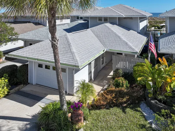 a aerial view of a house with a yard and potted plants