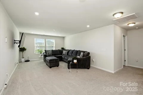 a living room with furniture and a ceiling fan
