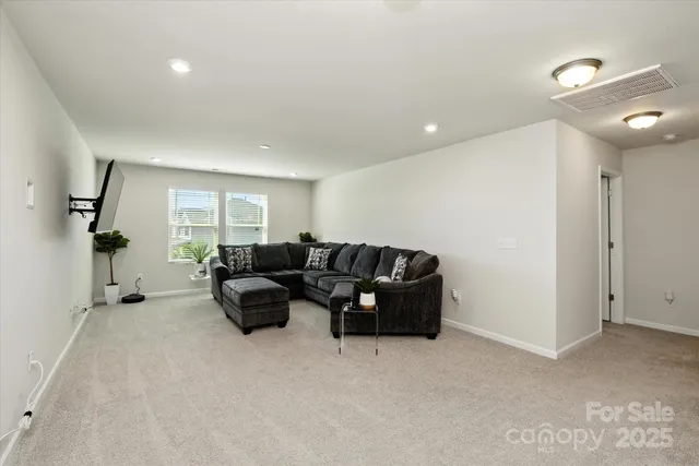 a living room with furniture and a ceiling fan