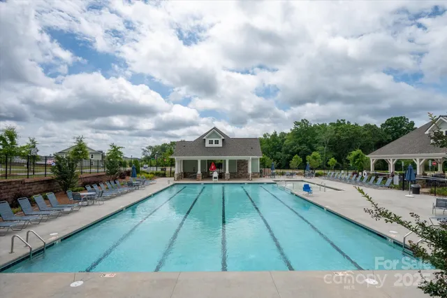 swimming pool view with sitting space and garden view