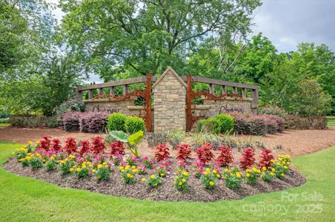 a view of a garden with flowers and trees