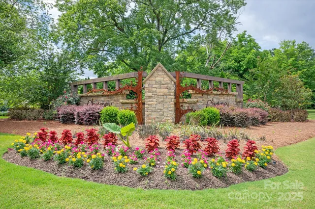 a view of a garden with flowers and trees