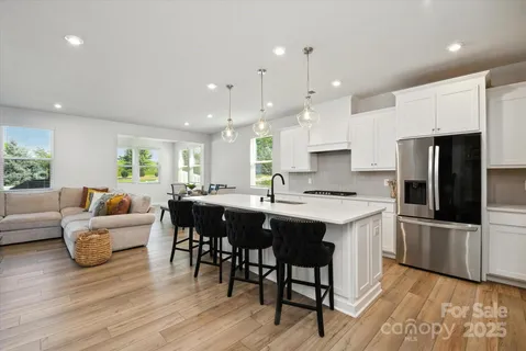 a large kitchen with a table and chairs