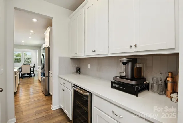 a kitchen with stainless steel appliances granite countertop a sink dishwasher stove and oven with wooden floor