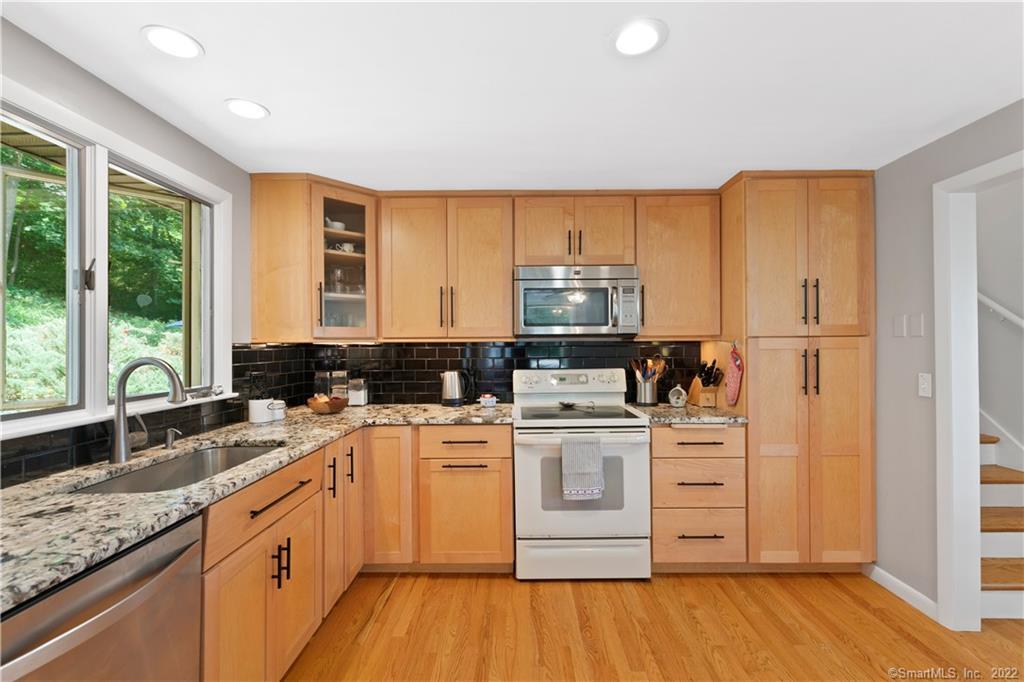 83 David Road Durham, CT 06422 - Photo 1 of 1 a kitchen with a sink a stove cabinets and wooden floor