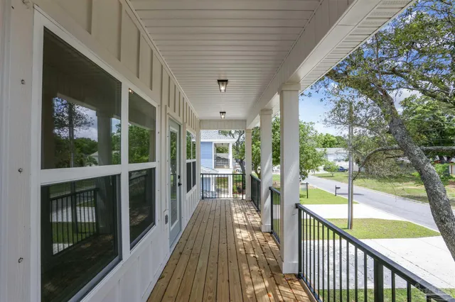 a view of a porch with wooden floor and fence