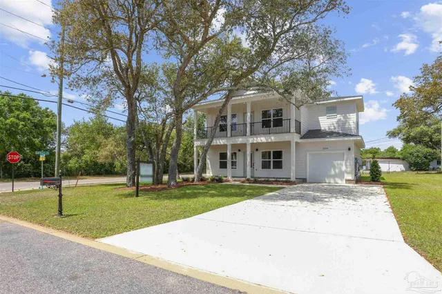 a front view of a building with a garden