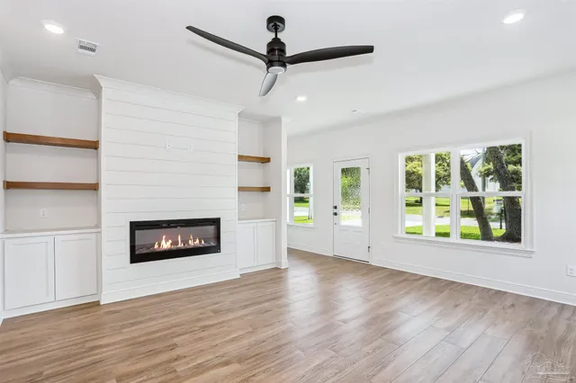 a view of a room with window fireplace and wooden floor