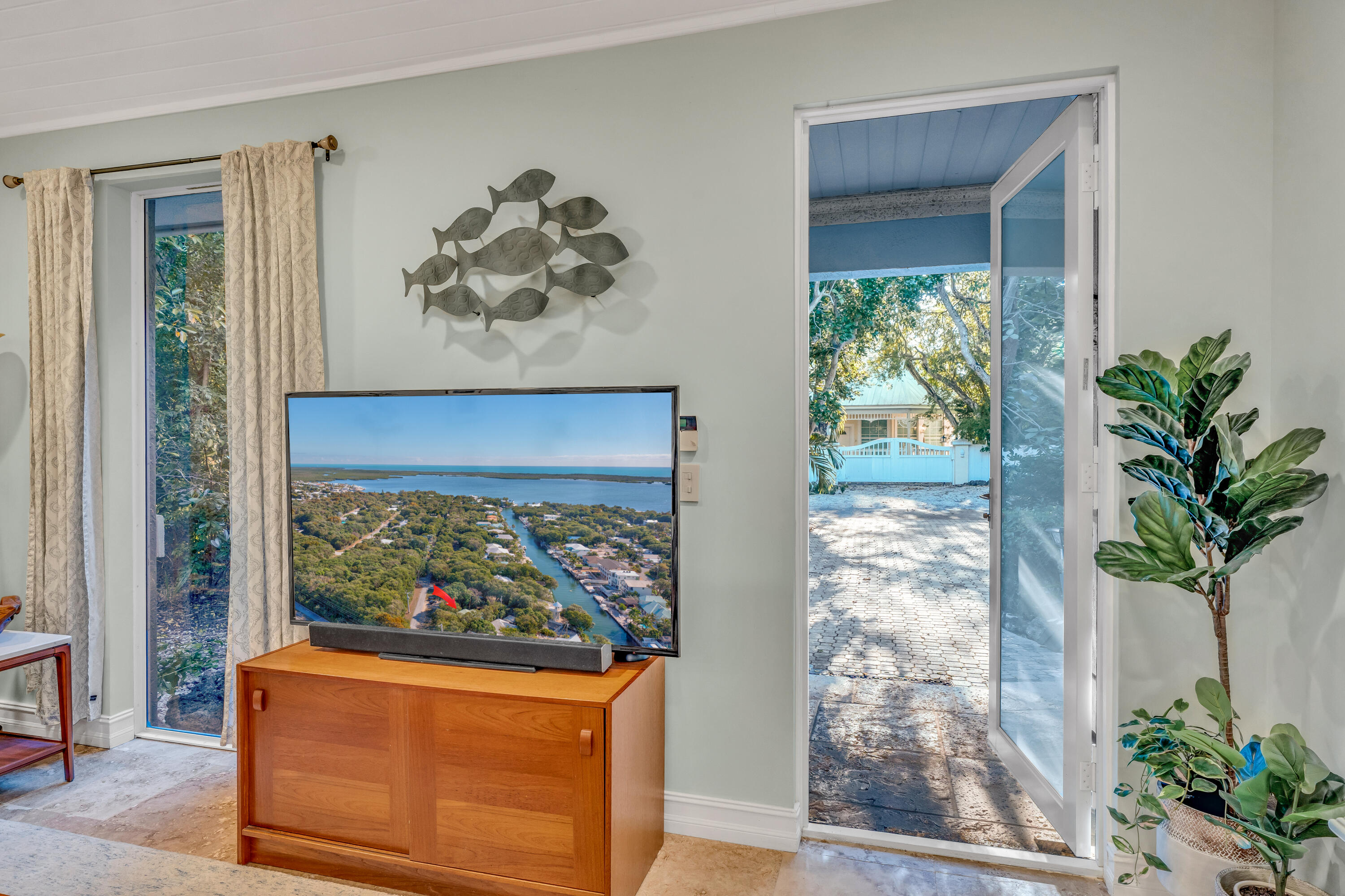 33 Blue Runner Street Key Largo, FL 33037 - Photo 12 of 60 a vase with flowers on a table in front of a window