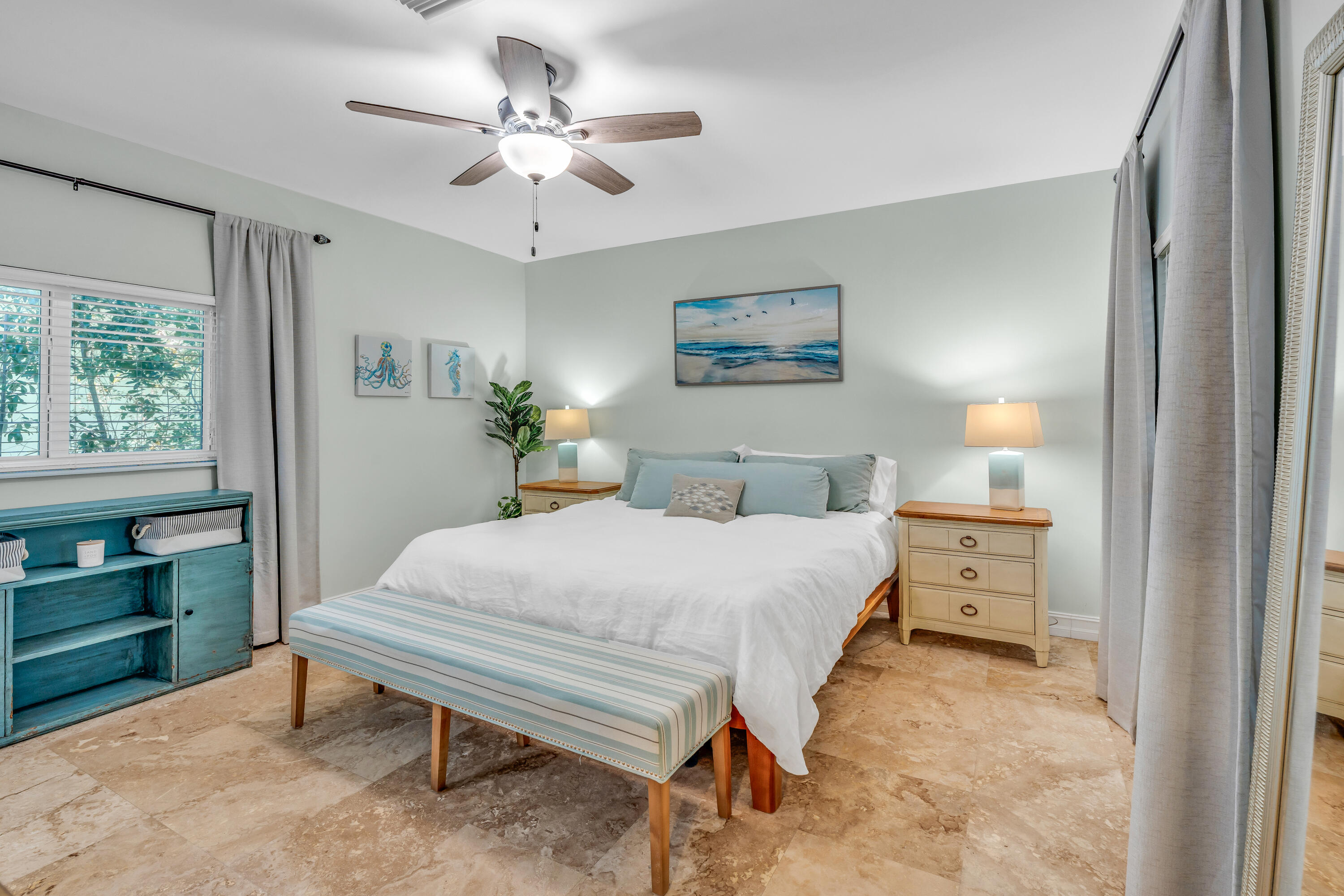 33 Blue Runner Street Key Largo, FL 33037 - Photo 21 of 60 a bedroom with a bed and a table in it