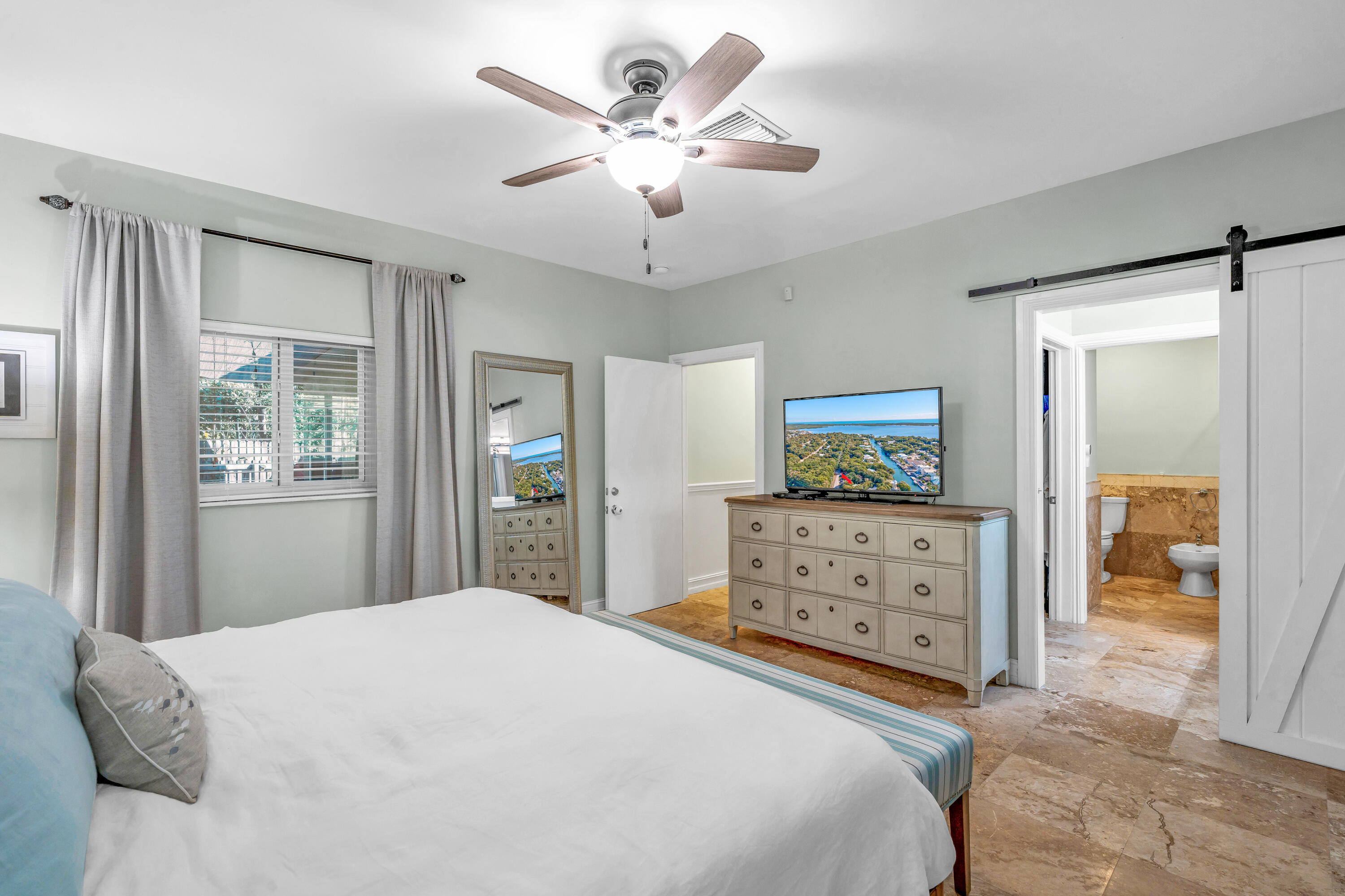 33 Blue Runner Street Key Largo, FL 33037 - Photo 23 of 60 a bedroom with a bed and a dresser