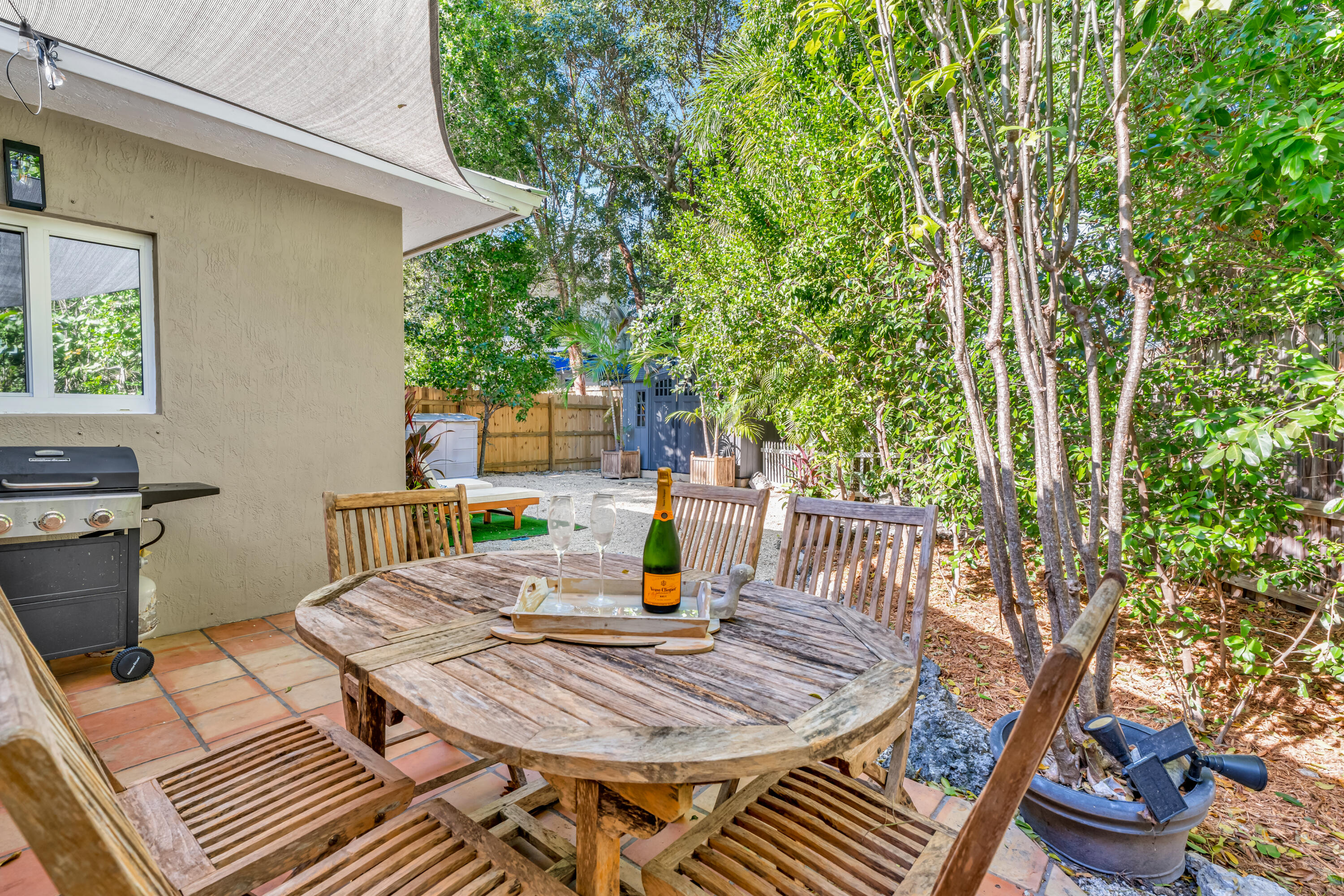 33 Blue Runner Street Key Largo, FL 33037 - Photo 39 of 60 a table and chairs sitting on a terrace