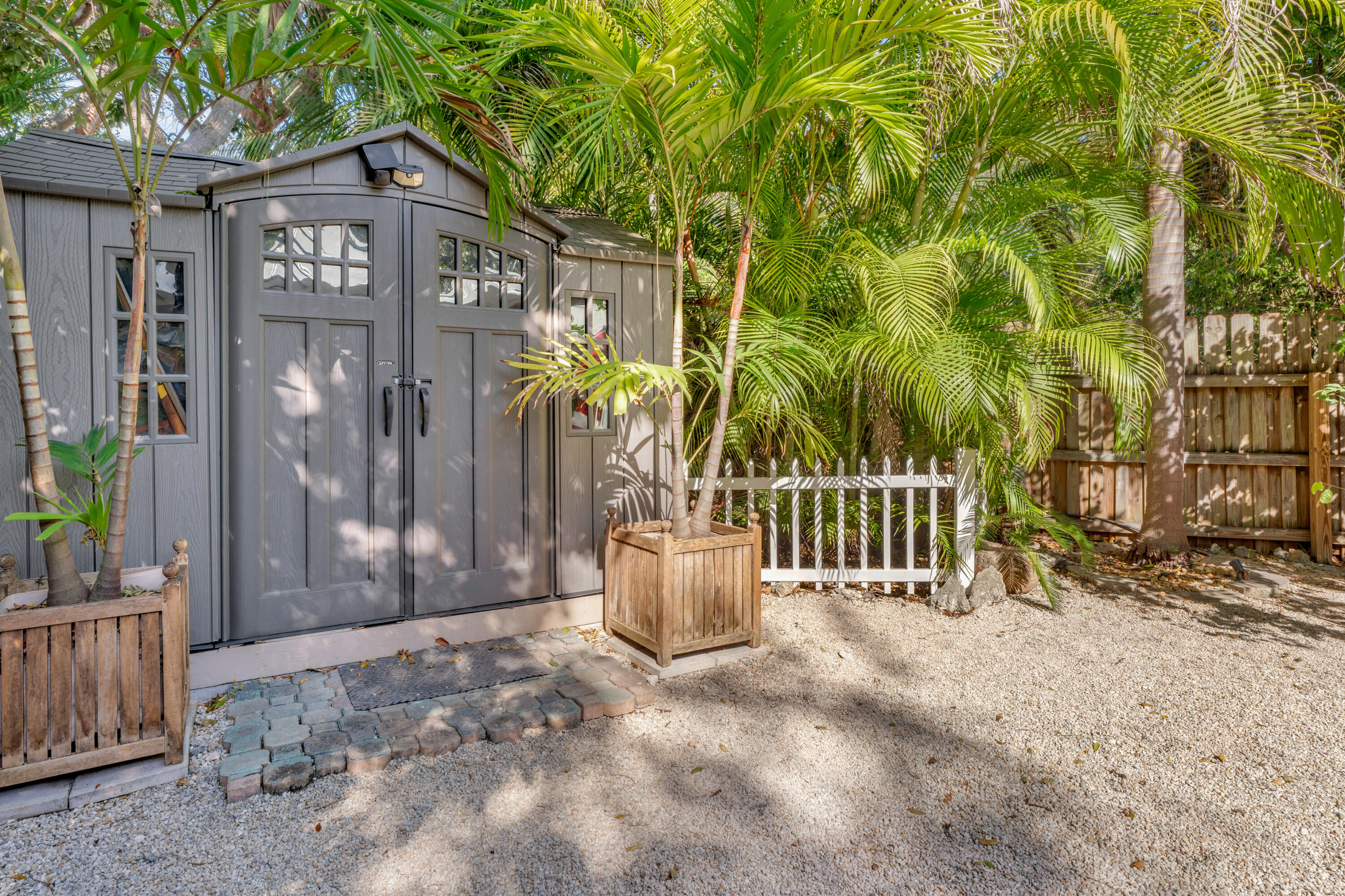 33 Blue Runner Street Key Largo, FL 33037 - Photo 41 of 60 a view of a brick house with potted plants and a large tree