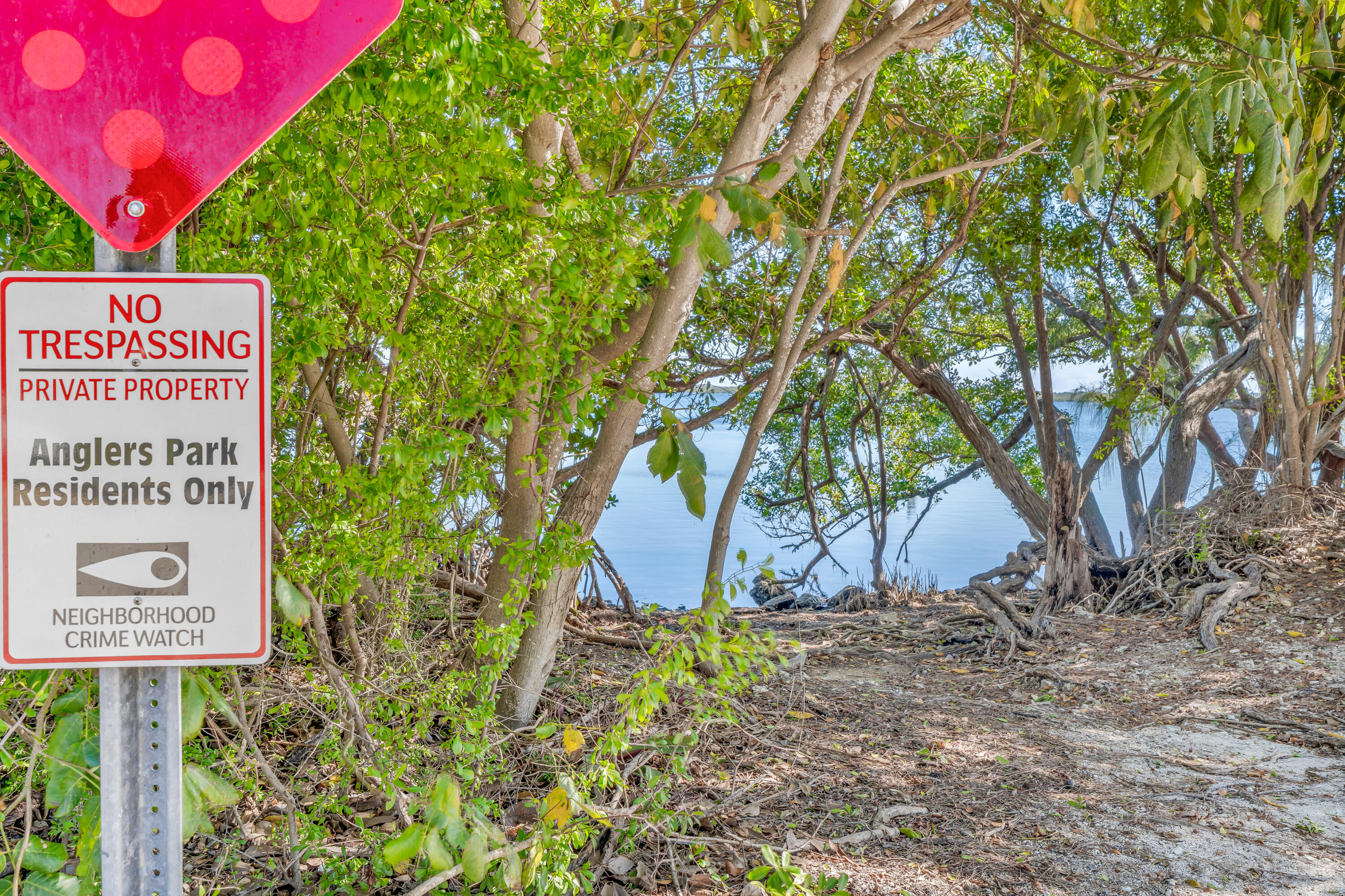 33 Blue Runner Street Key Largo, FL 33037 - Photo 54 of 60 a sign that is sitting in front of a tree