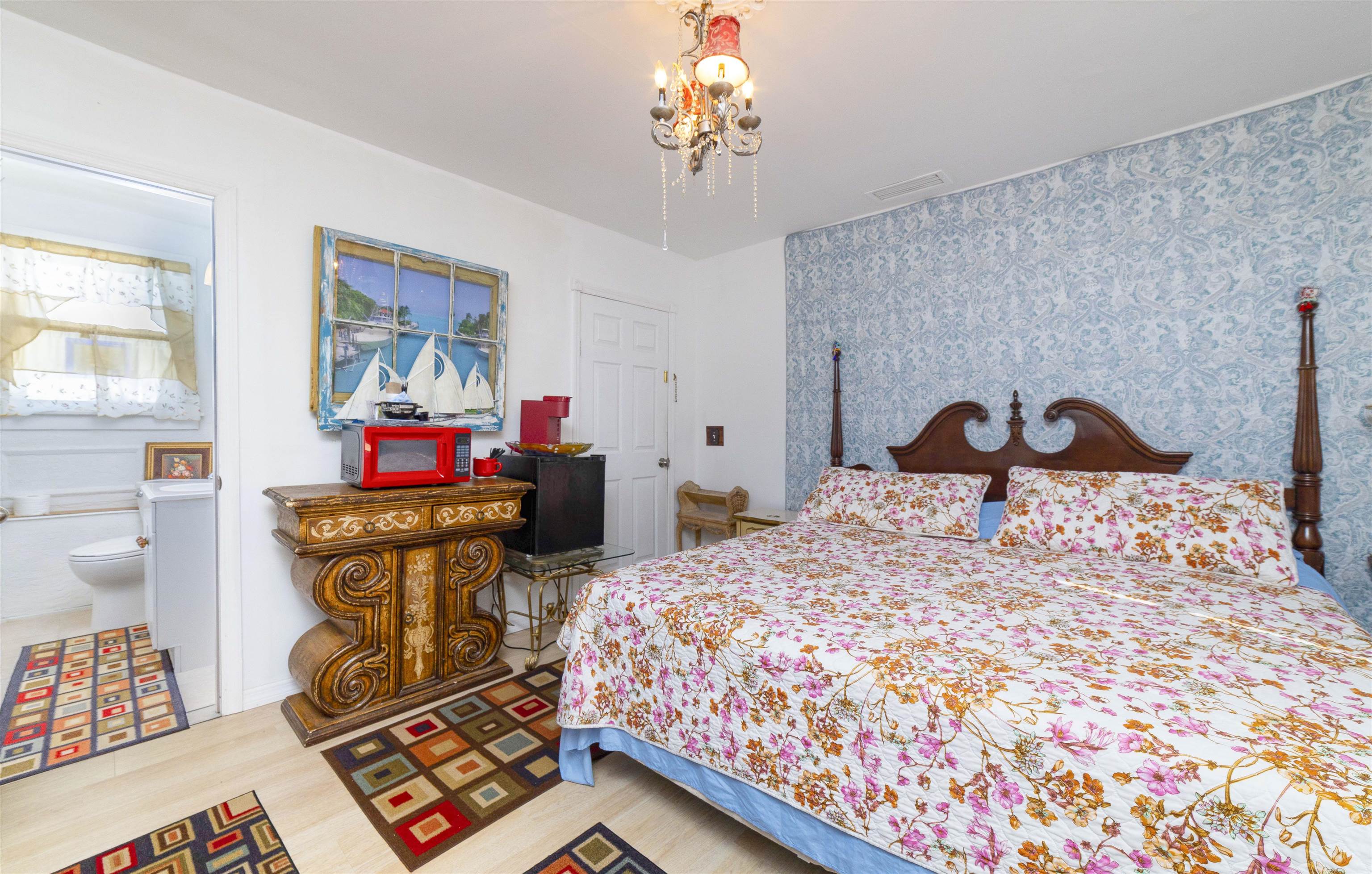 77 Oneida Street St. Augustine, FL 32084 - Photo 13 of 26 a bedroom with a bed and wooden floor