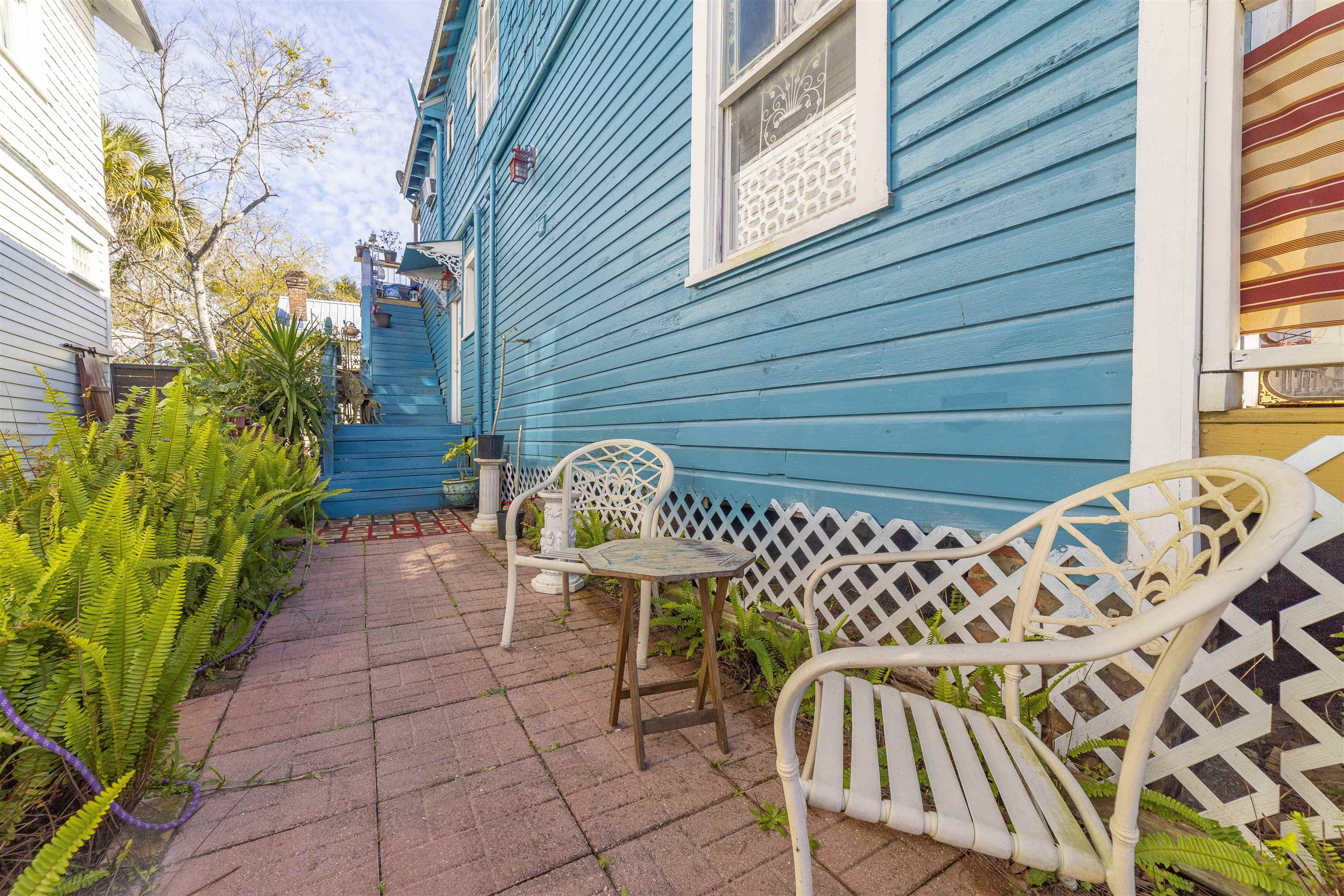 77 Oneida Street St. Augustine, FL 32084 - Photo 17 of 26 a view of a chairs and table on the patio