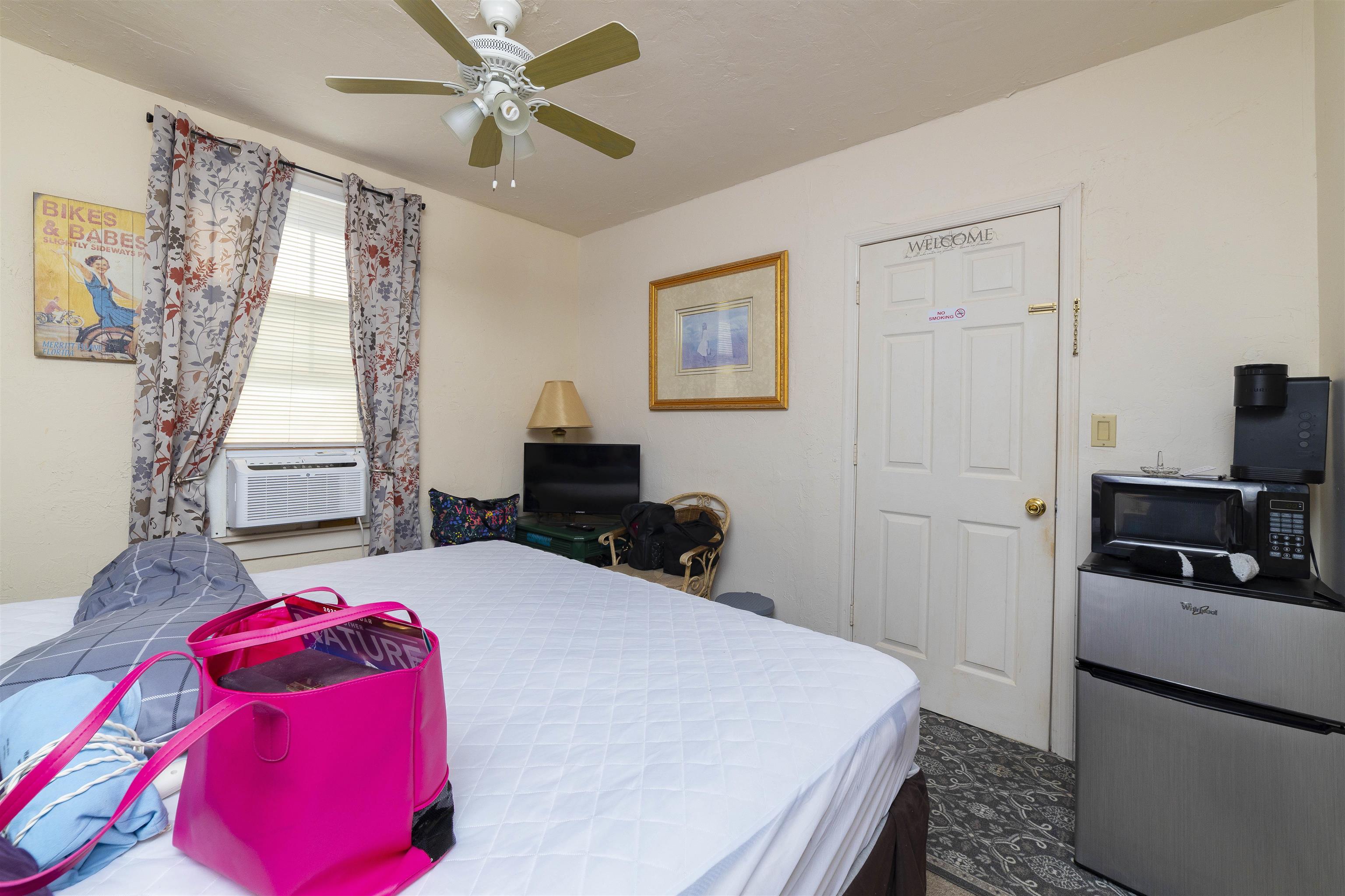 77 Oneida Street St. Augustine, FL 32084 - Photo 22 of 26 a bedroom with a bed and a window