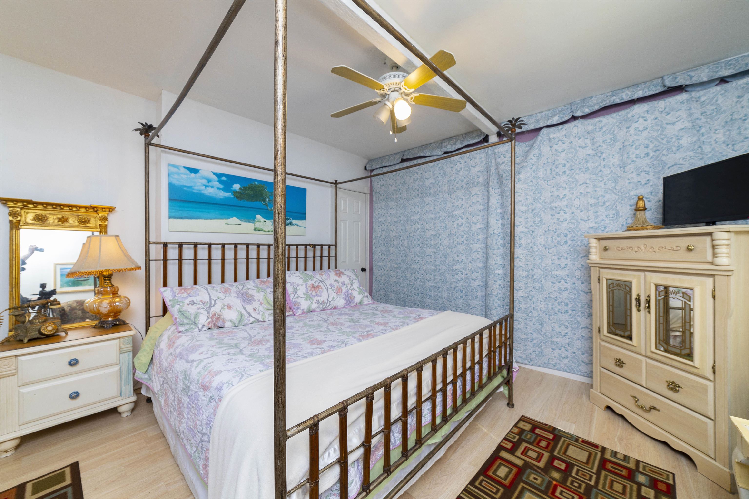 77 Oneida Street St. Augustine, FL 32084 - Photo 6 of 26 a bedroom with a bed and a flat tv screen on the dresser