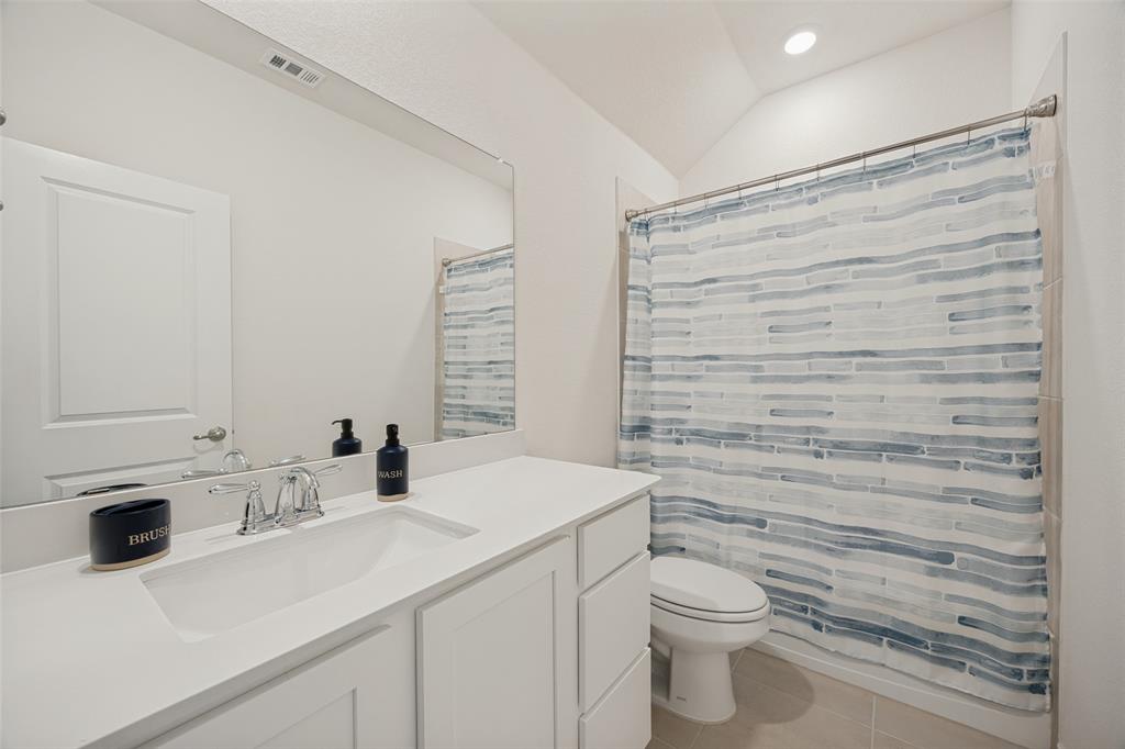 3816 Blacksmith Road Aubrey, TX 76227 - Photo 14 of 30 White vanity with an integrated sink, chrome faucet, and expansive wall-mounted mirror
