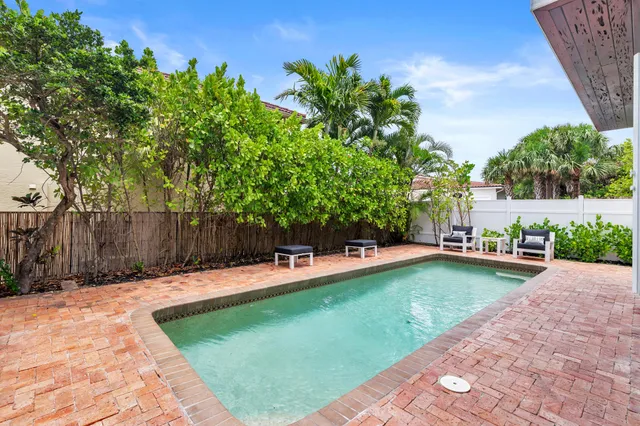 a view of a dining room with furniture and a chandelier