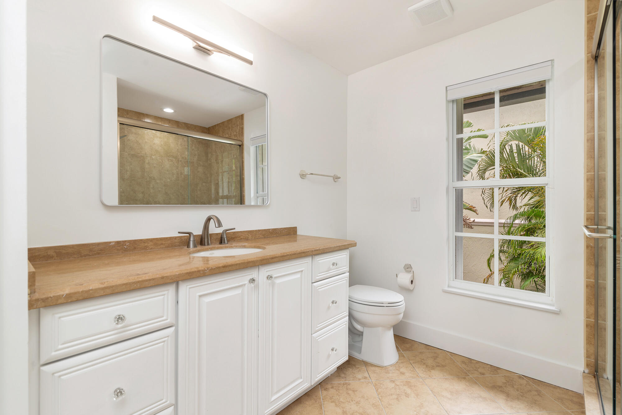 460 Surfside Lane Juno Beach, FL 33408 - Photo 29 of 51 a bathroom with a toilet a sink a vanity and mirror