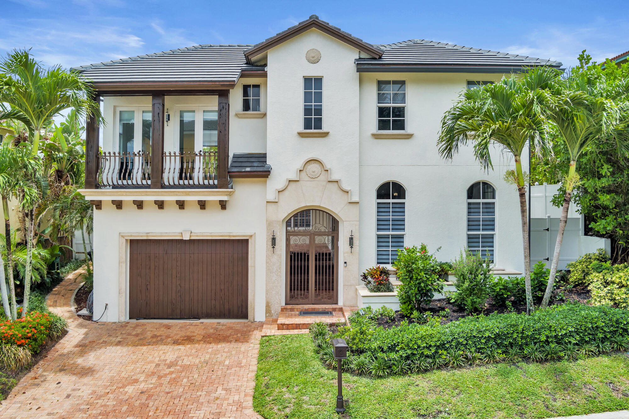 460 Surfside Lane Juno Beach, FL 33408 - Photo 3 of 51 a front view of a house with garden