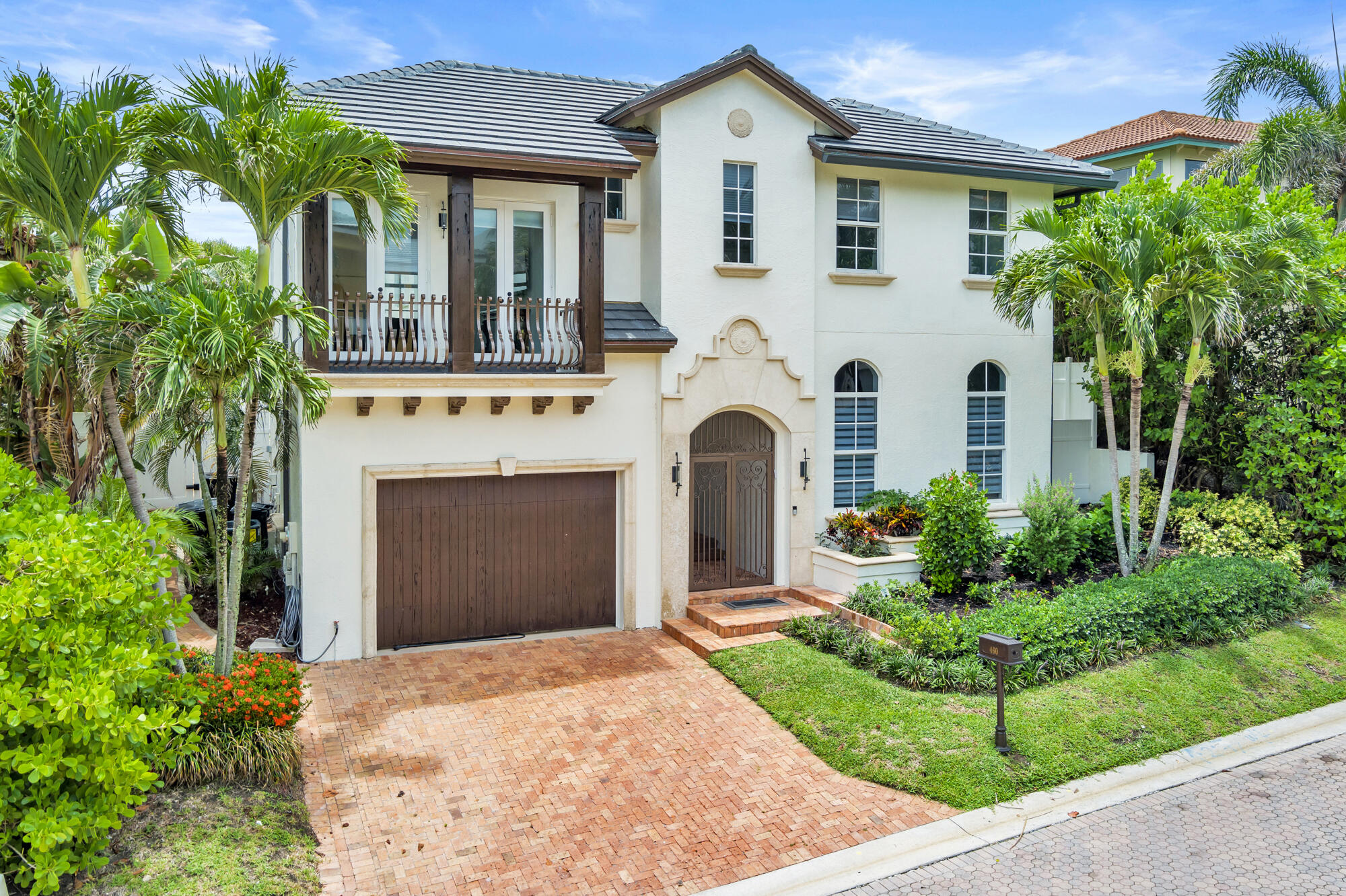 460 Surfside Lane Juno Beach, FL 33408 - Photo 32 of 51 a front view of a house with a garden