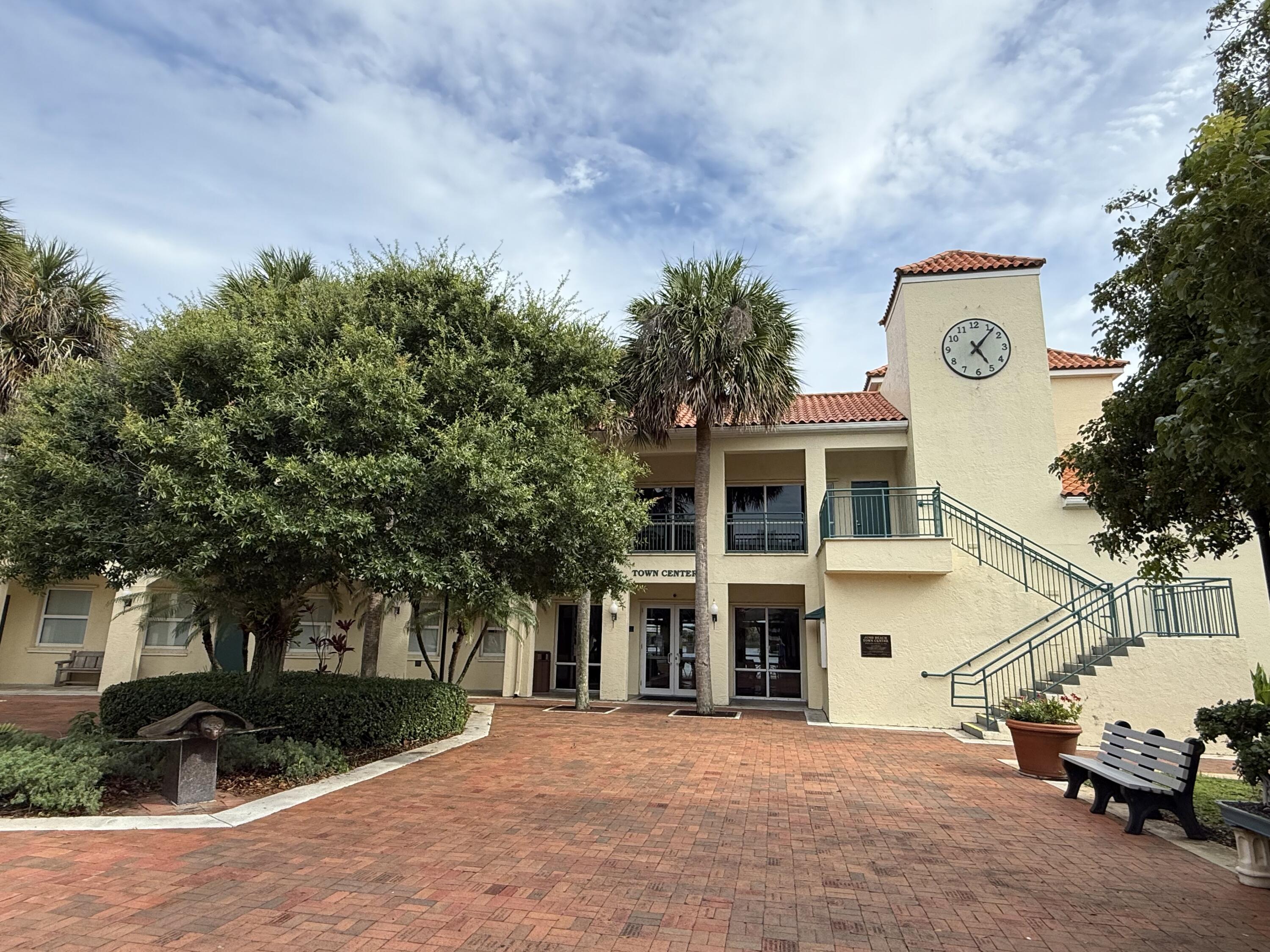 460 Surfside Lane Juno Beach, FL 33408 - Photo 45 of 51 a view of a white house with a large tree and plants