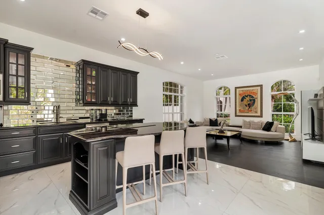 a kitchen with stainless steel appliances granite countertop a stove and cabinets