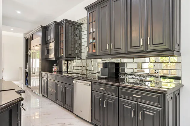 a kitchen with stainless steel appliances granite countertop a stove and a sink