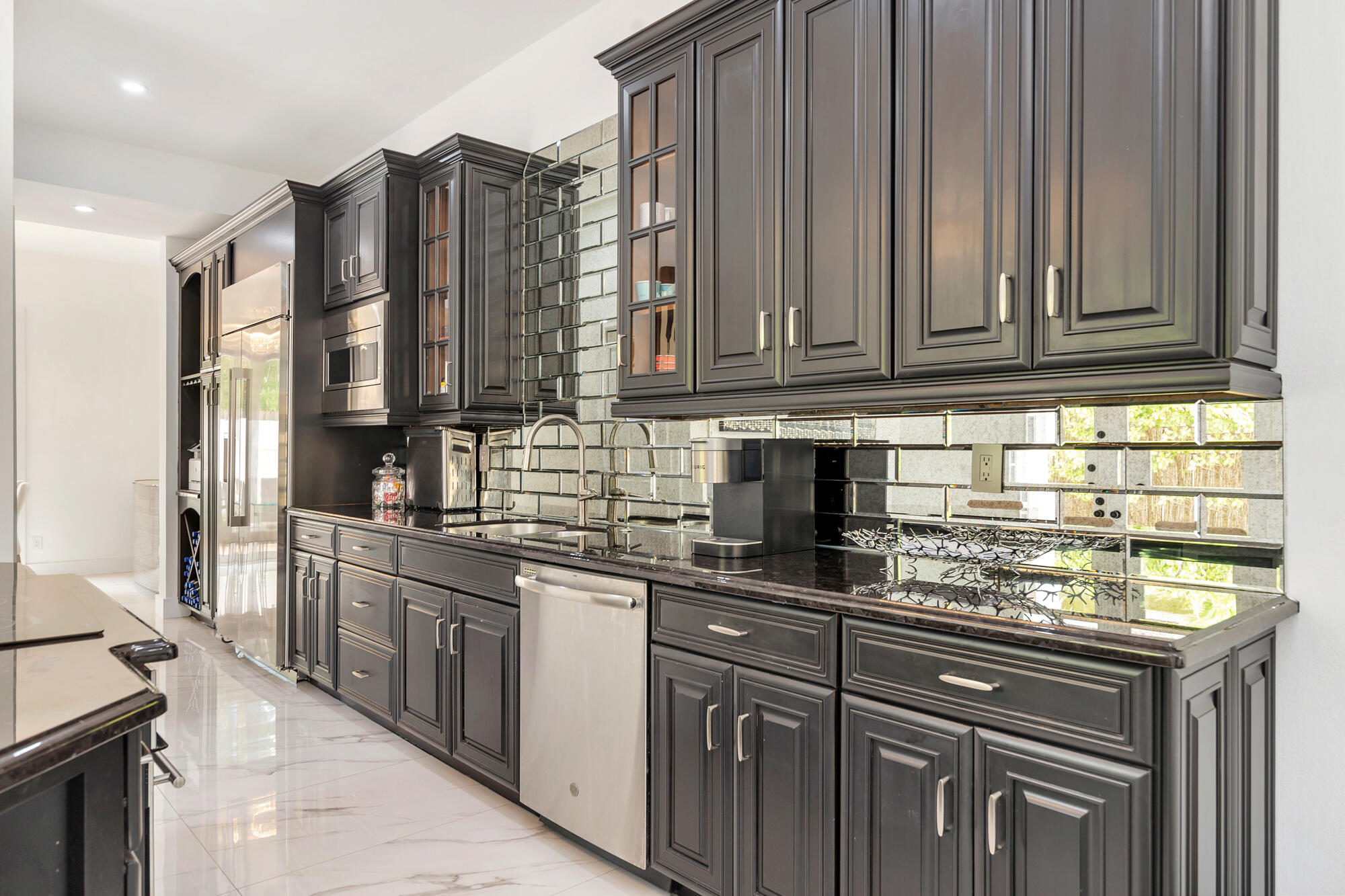 460 Surfside Lane Juno Beach, FL 33408 - Photo 10 of 51 a kitchen with stainless steel appliances granite countertop a sink a stove a refrigerator and cabinets