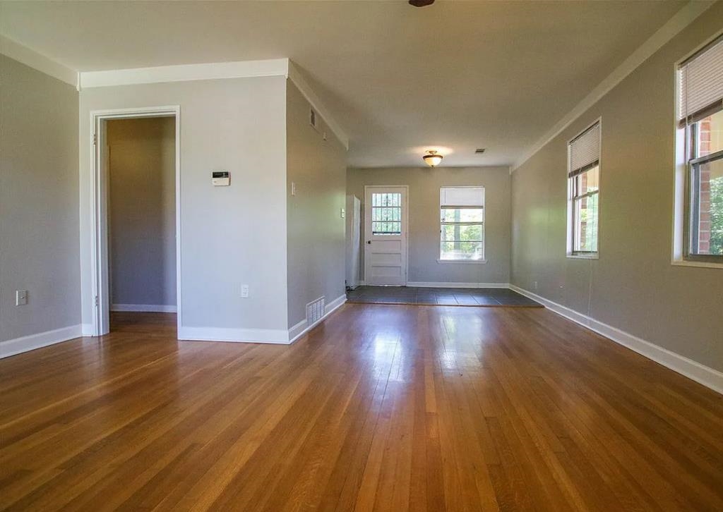 4849 Sea Isle Road Memphis, TN 38117 - Photo 3 of 13 a view of an empty room with wooden floor and window