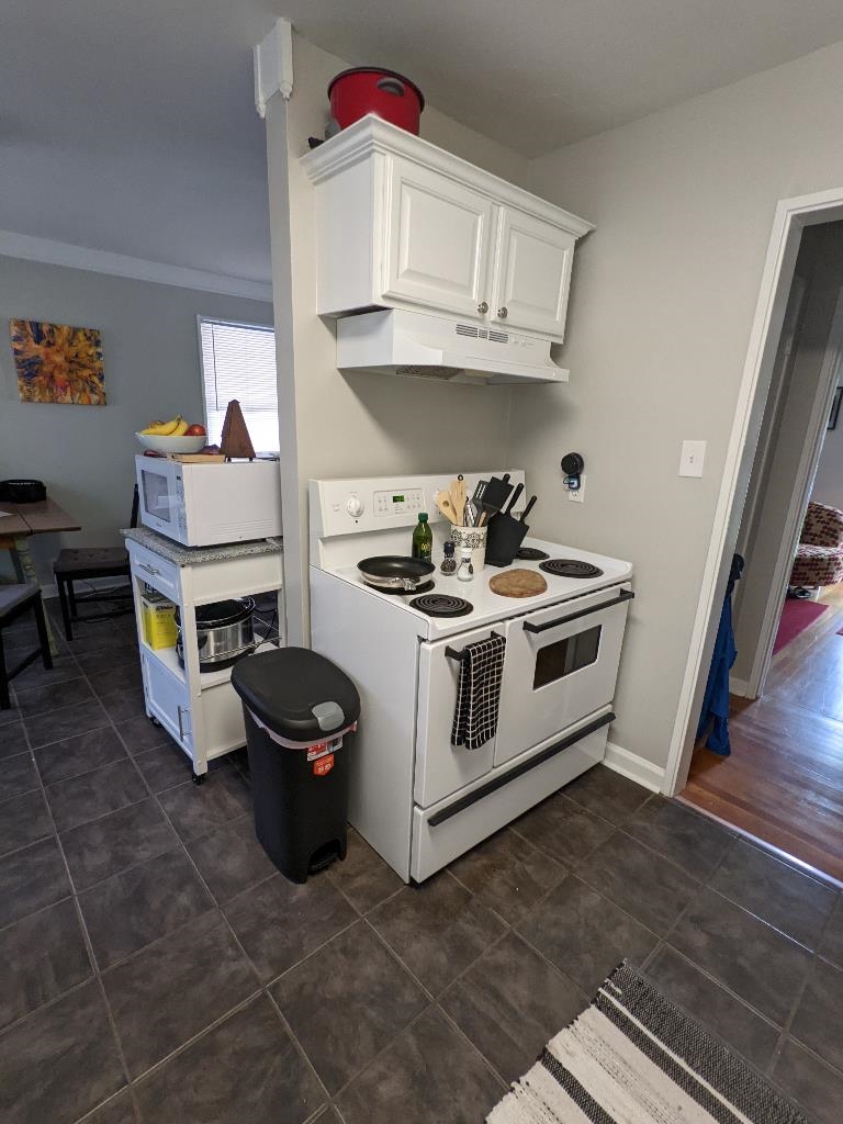 4849 Sea Isle Road Memphis, TN 38117 - Photo 8 of 13 a kitchen with stainless steel appliances a white stove top oven a sink and dishwasher