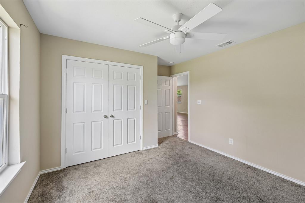 433 Whitney Court Rio Vista, TX 76093 - Photo 16 of 27 an empty room with a ceiling fan and a window