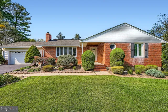 a view of a house with a yard and sitting area