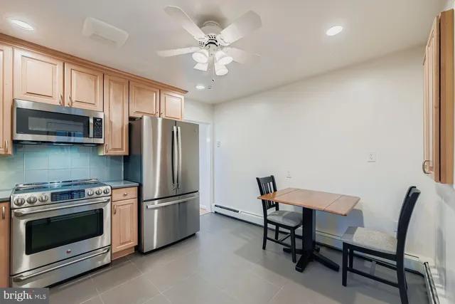 a kitchen with stainless steel appliances a stove a microwave and a refrigerator